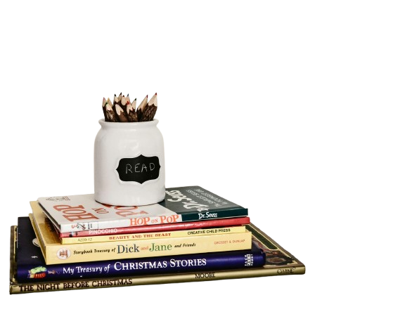 Colorful books stacked with a pencil holder.