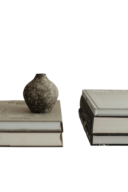 A textured vase atop stacked books