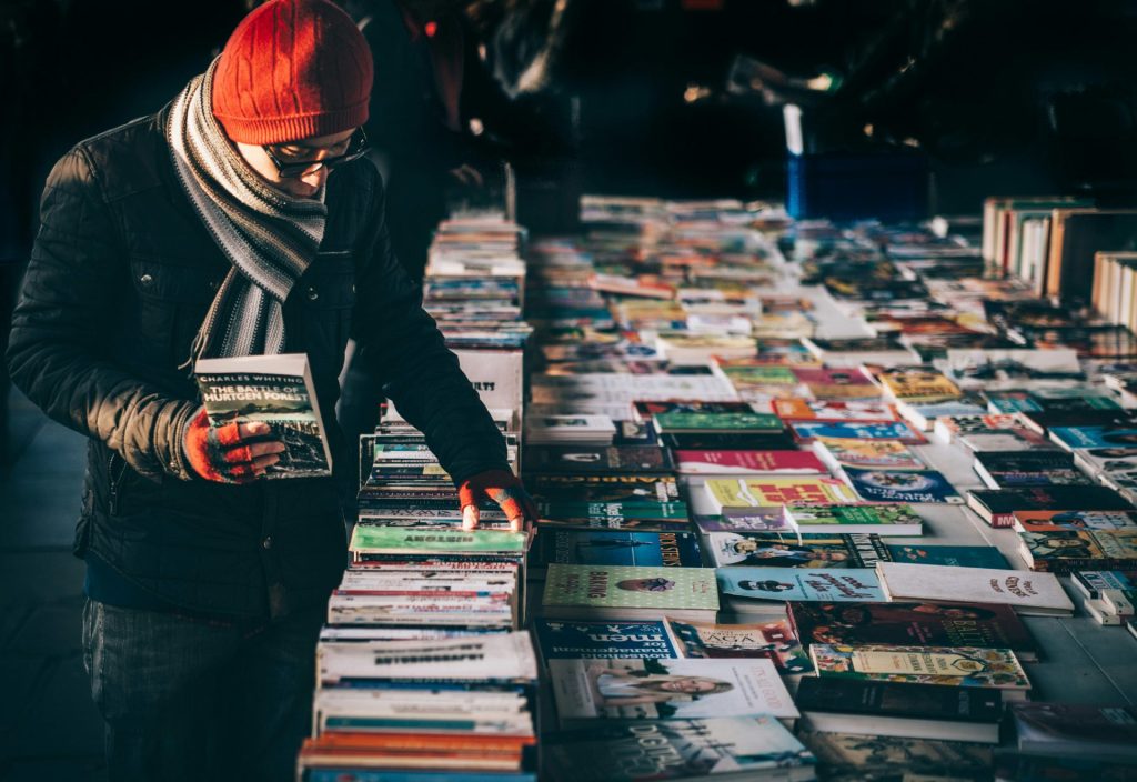 Person browsing colorful book display